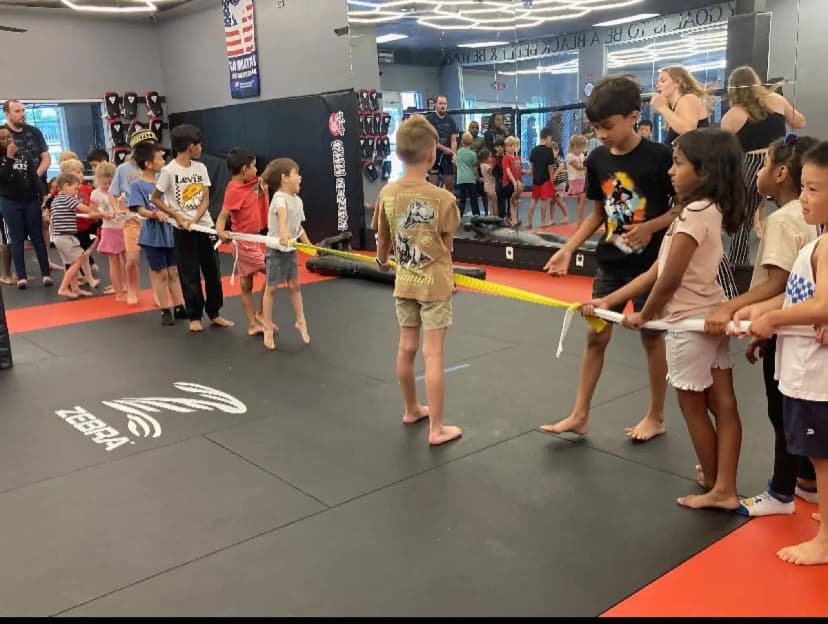 Kids playing tug of war at Kaizen MMA summer camp
