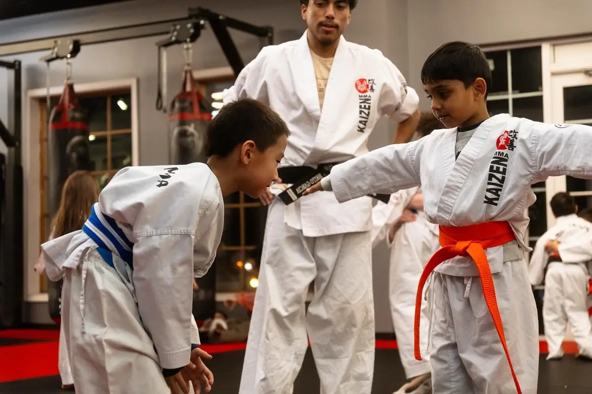 Instructor teaching young kids martial arts at Kaizen MMA