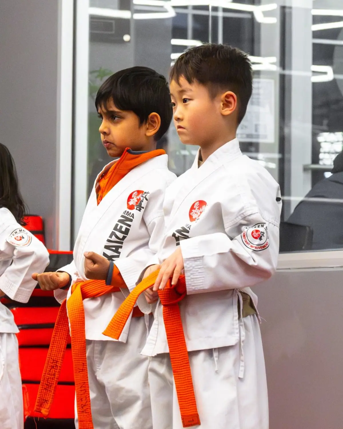 Focused kids in gis during martial arts training
