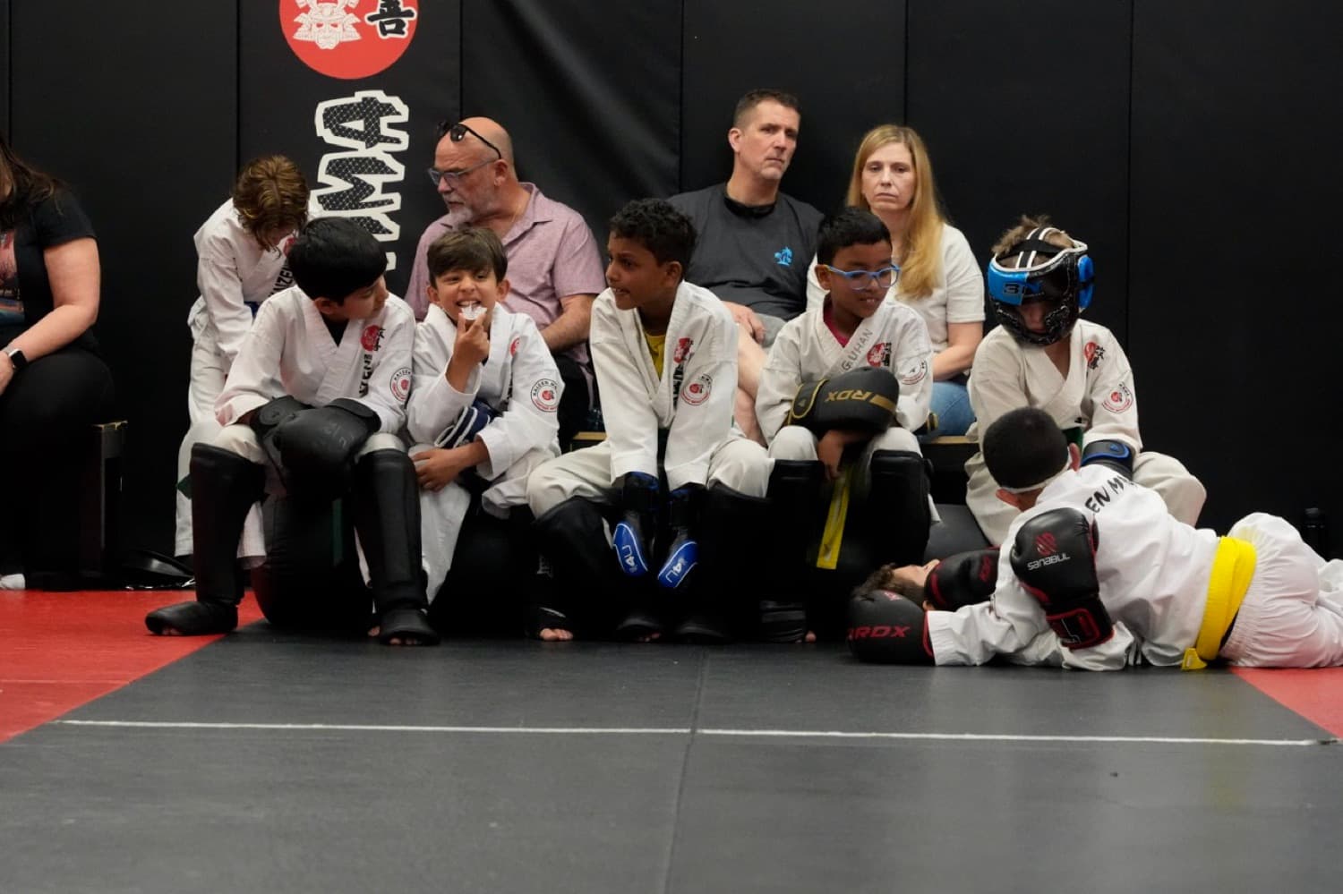 Kids in gear on the mats at Kaizen MMA South Riding